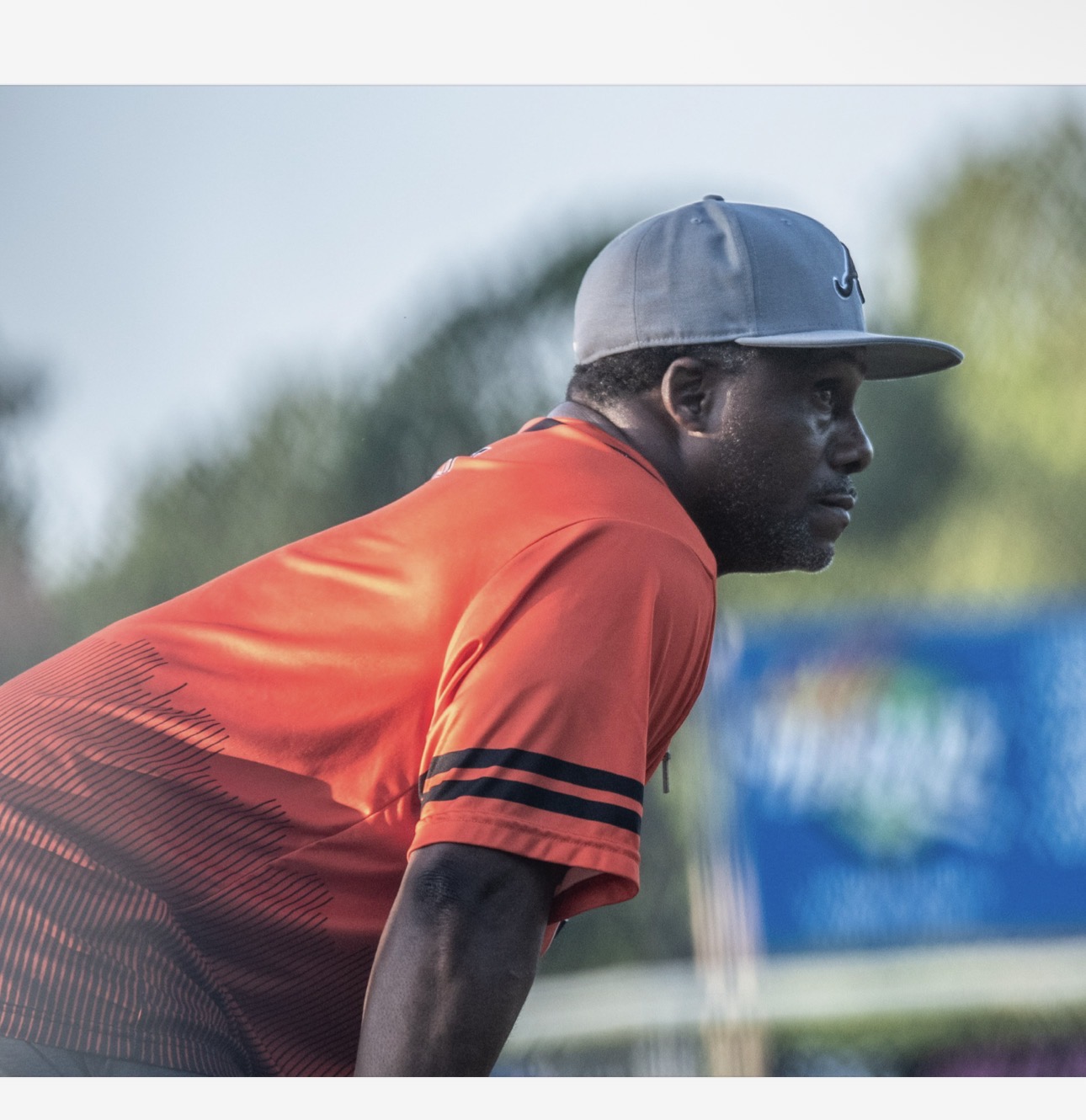 A coach leaning in, eyes on the play