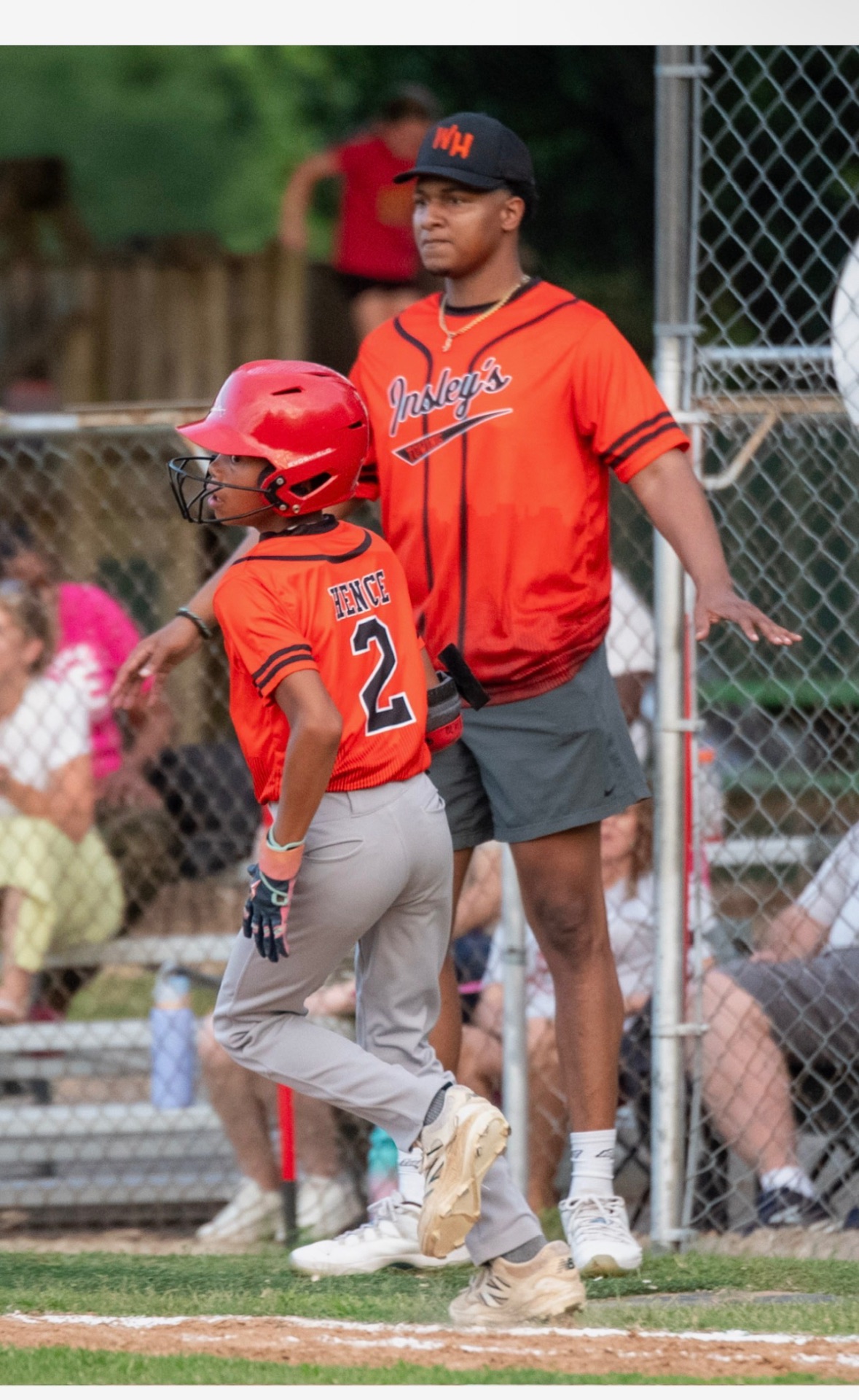 A coach sending a base runner home during a game
